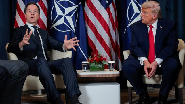 U.S. President Donald Trump (R) listens as NATO Secretary General Mark Rutte speaks 